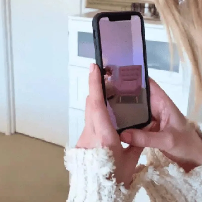 A shopper placing a Brosa piece in their home on a phone